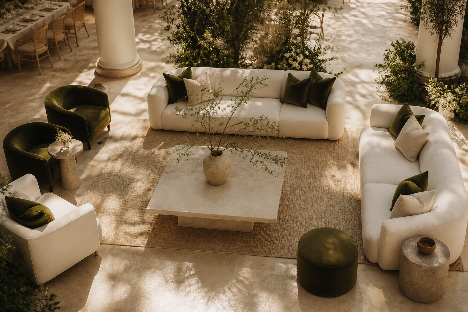 A sophisticated minimalist wedding lounge area with ivory linen sofas and stone furniture in a modern venue.